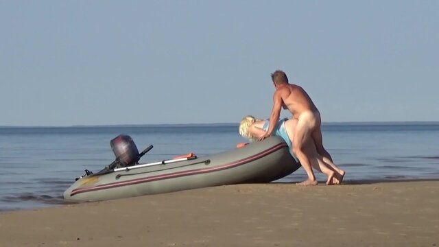 Blonde COUGAR gives a head and shows off her round backside at the beach